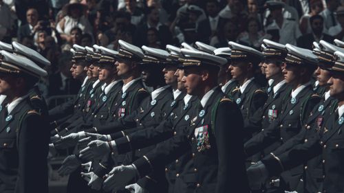 Free Military officers in formal uniforms marching during a ceremonial parade. Stock Photo