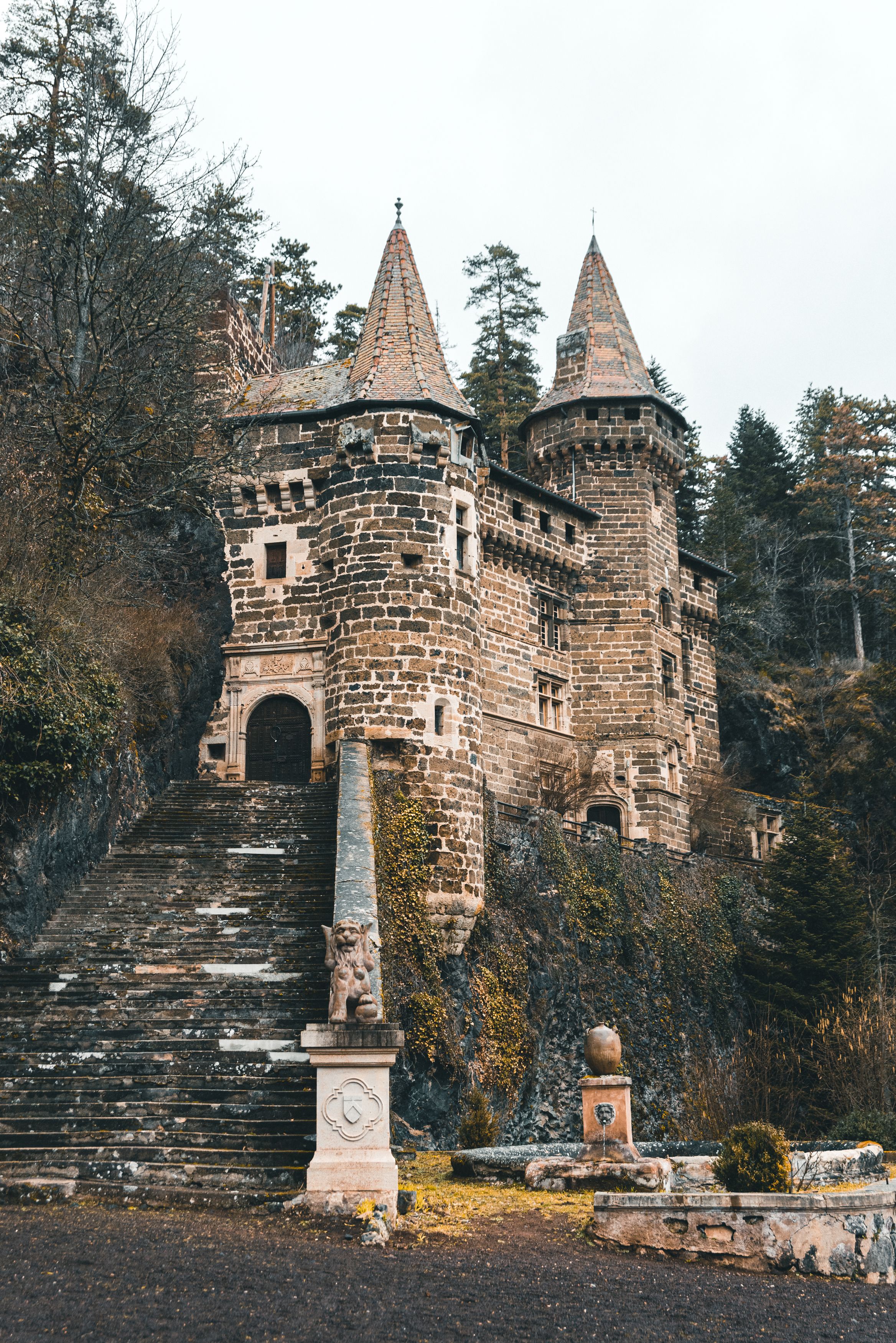 Medieval Castle in Lush Forest Setting · Free Stock Photo