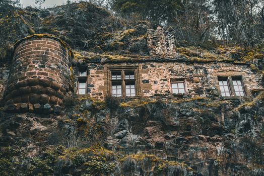 Historic stone fortress nestled in a rugged cliffside setting, showcasing medieval architecture.