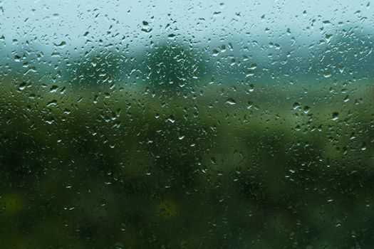 Captivating view through raindrop-covered window in Belfast, evoking a peaceful mood.