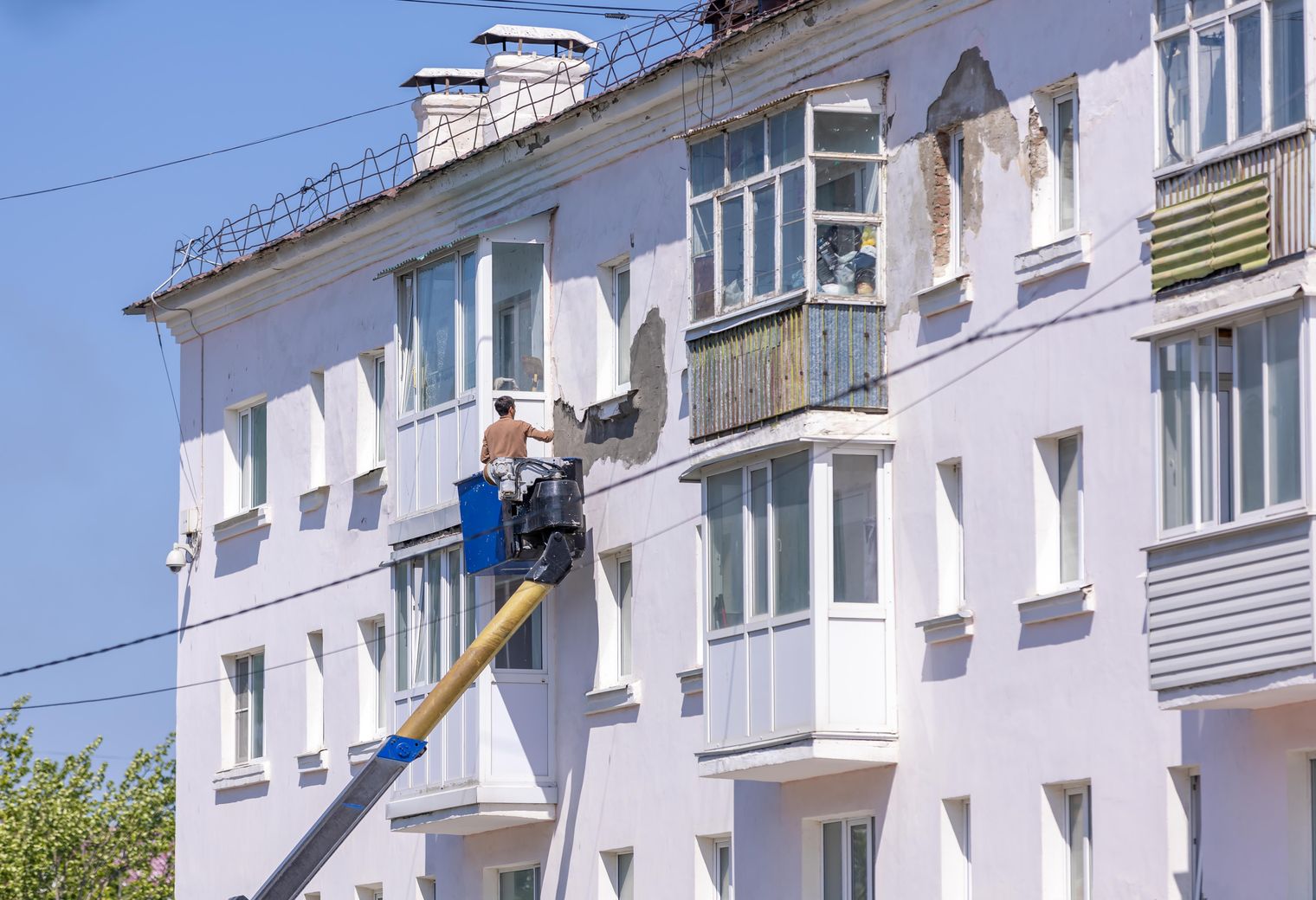 Commercial facade being repainted from an access platform