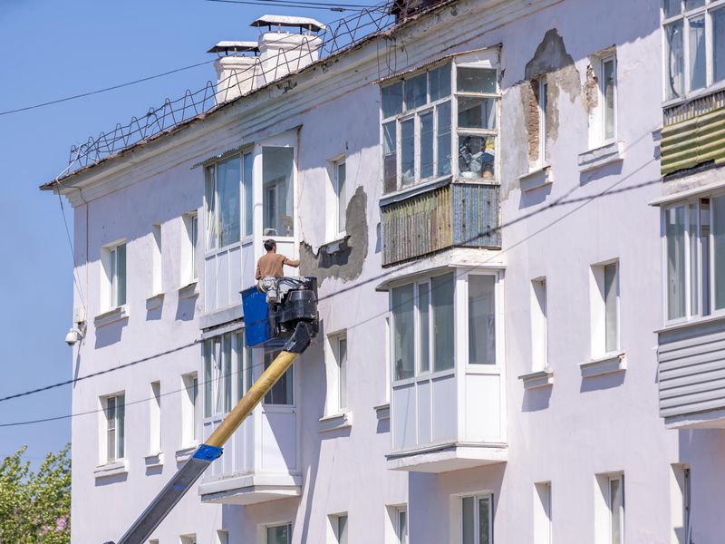 An apartment building facade being renovated