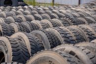 A large outdoor storage yard filled with rows of old tires, ideal for concepts like recycling or industrial use.
