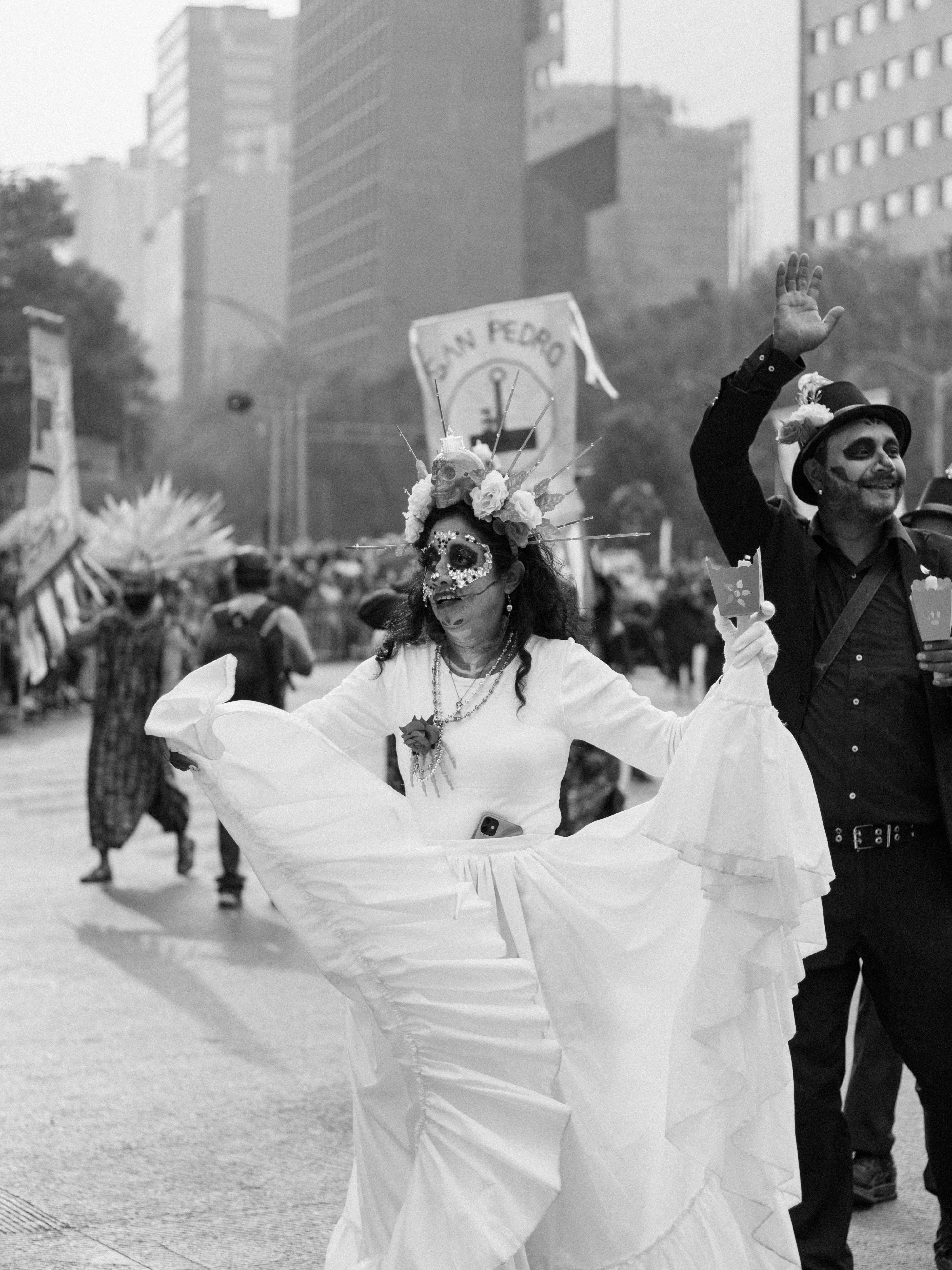 Festive Day of the Dead parade in Mexico City showcasing vibrant traditions and cultural attire.