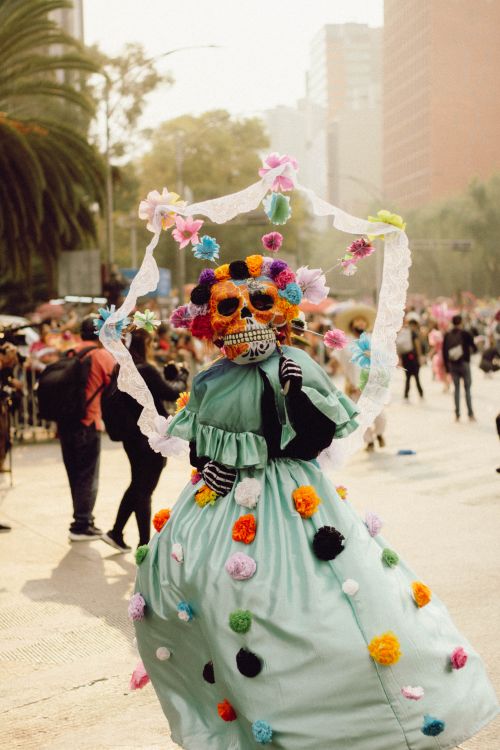 Free A colorful Day of the Dead parade featuring traditional Catrina costumes in the historic heart of Mexico City. Stock Photo
