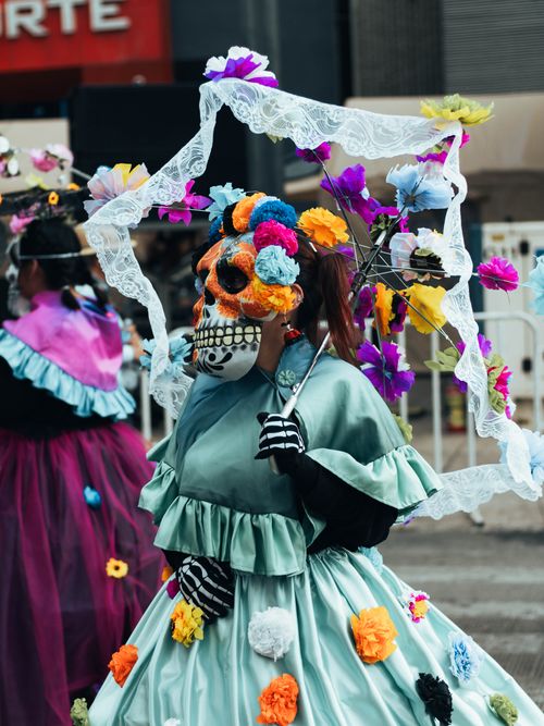 Free Colorful Día de los Muertos parade participants wearing traditional Catrina costumes in Mexico City. Stock Photo