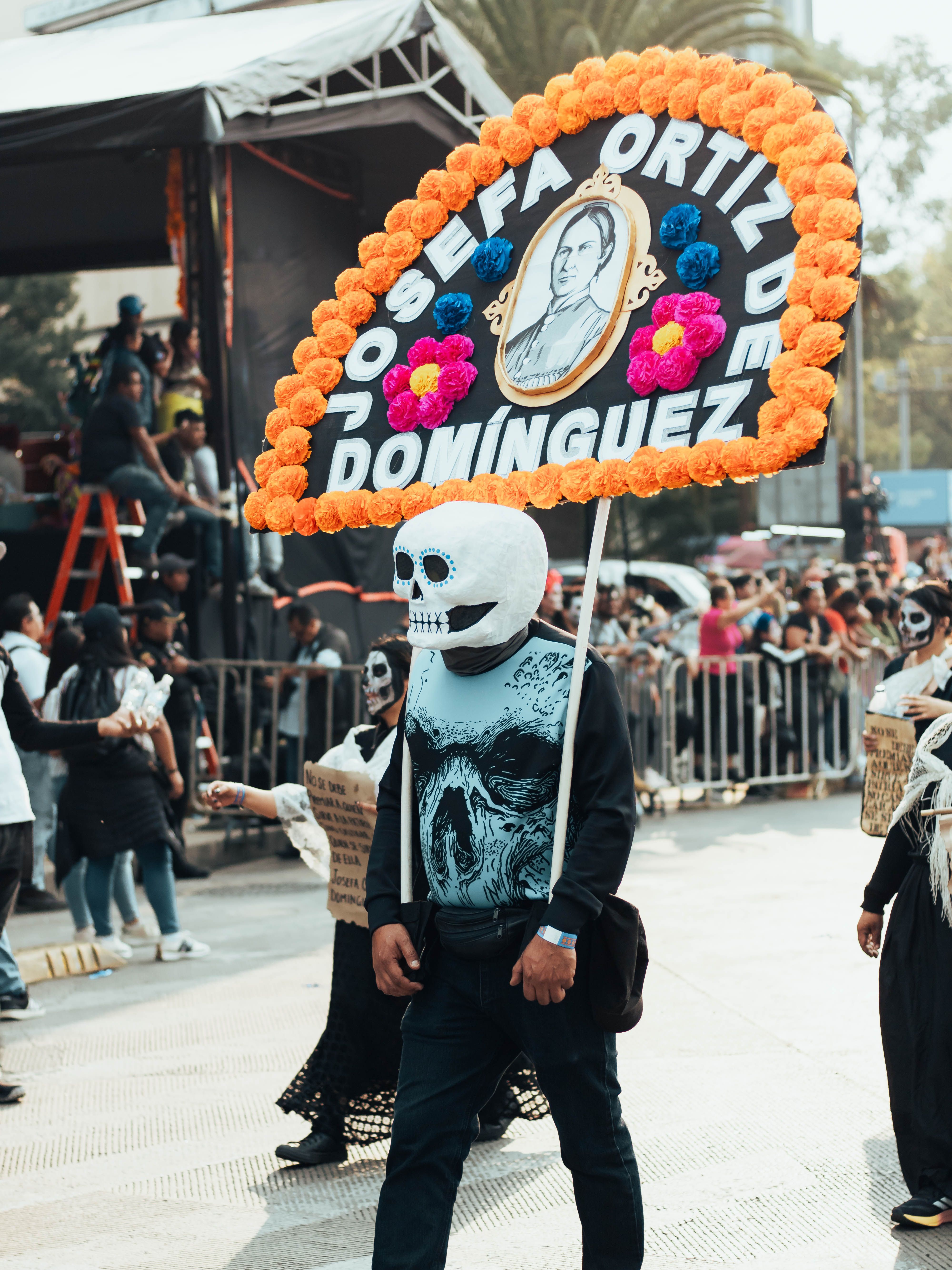 Vibrant Day of the Dead parade featuring traditional costumes and festive decorations in Mexico City.