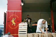 两名工人在汉堡市场的摊位上卸货