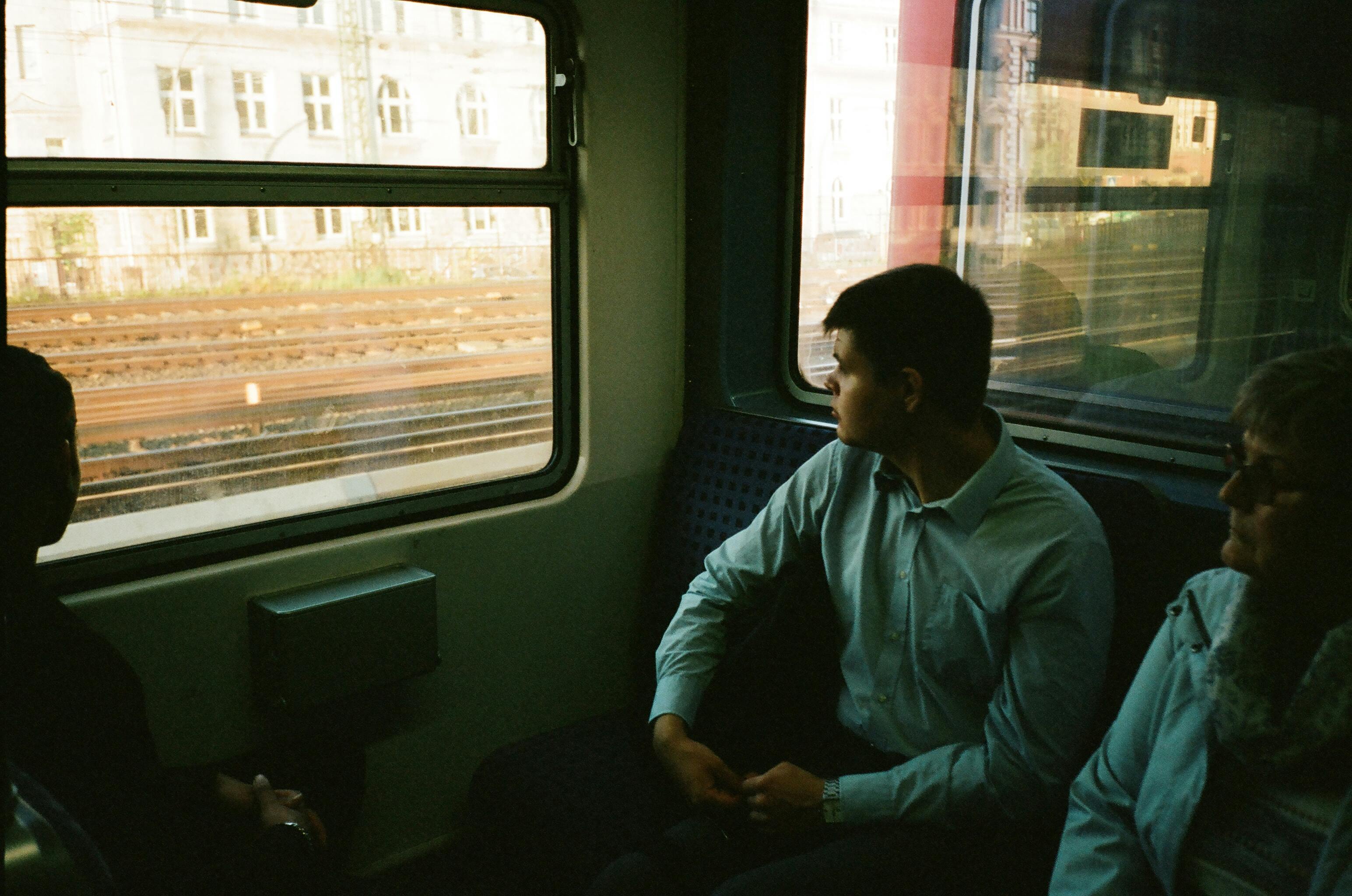 Two people sitting inside the train | Photo: Pexels