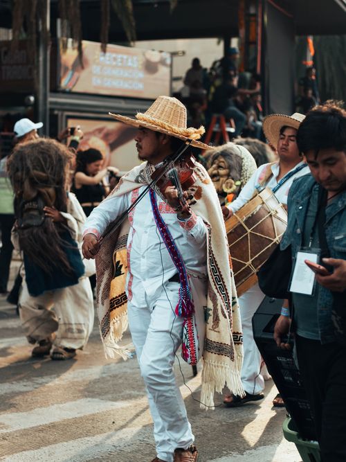 Free Colorful parade in Mexico City celebrating Day of the Dead with traditional costumes and music. Stock Photo
