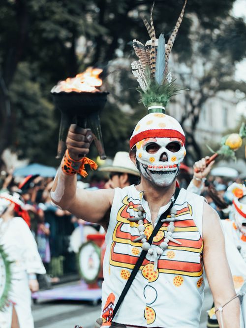 Free A vibrant Day of the Dead parade participant in traditional costume and skull makeup in Mexico City. Stock Photo
