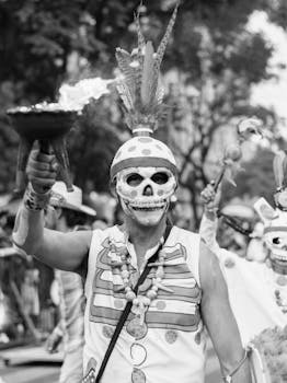 Costumed participants celebrate Día de Muertos in Mexico City, showcasing vibrant Mexican culture.