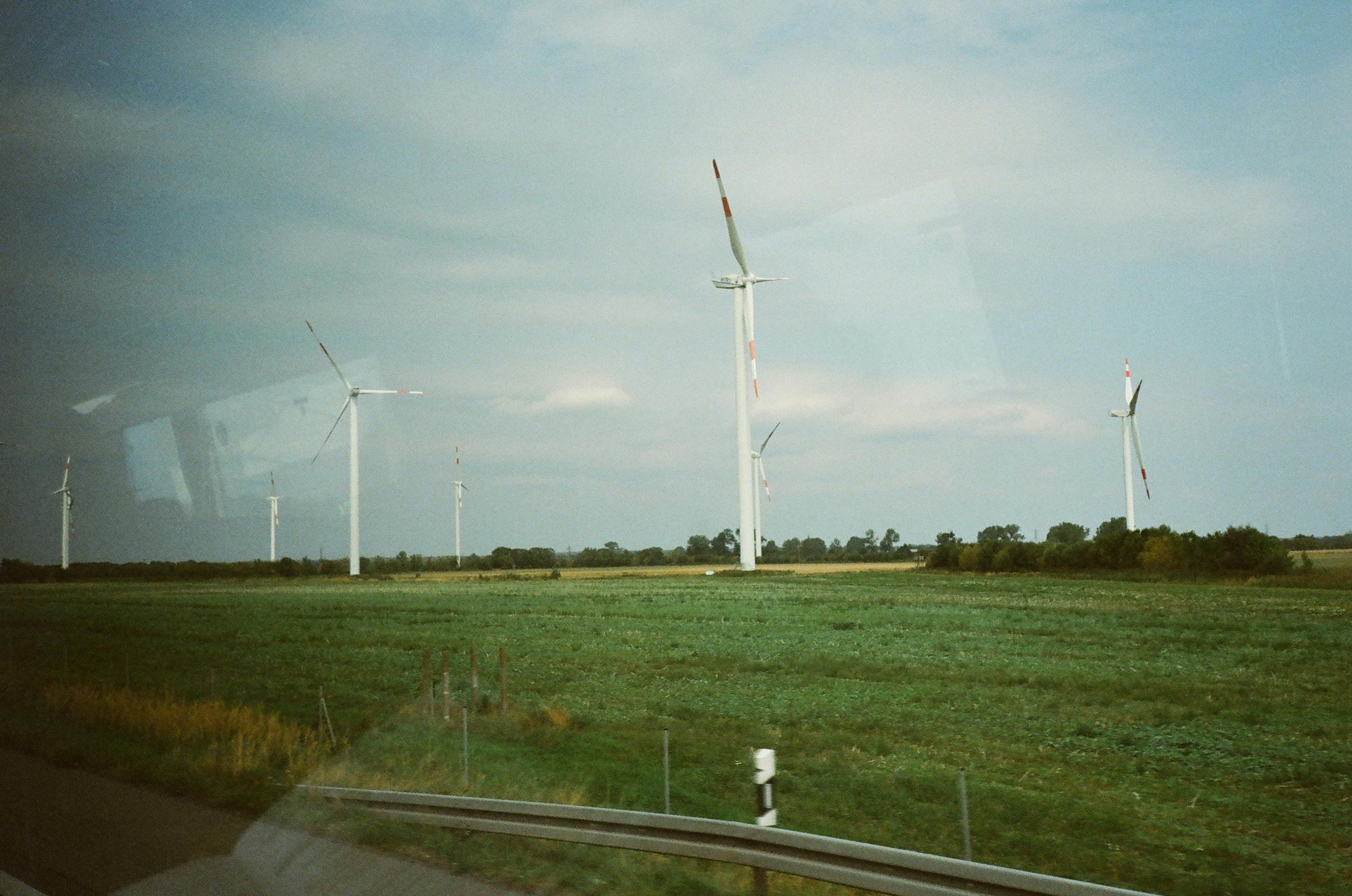 Wind turbines stand tall in a scenic countryside landscape capturing renewable energy.