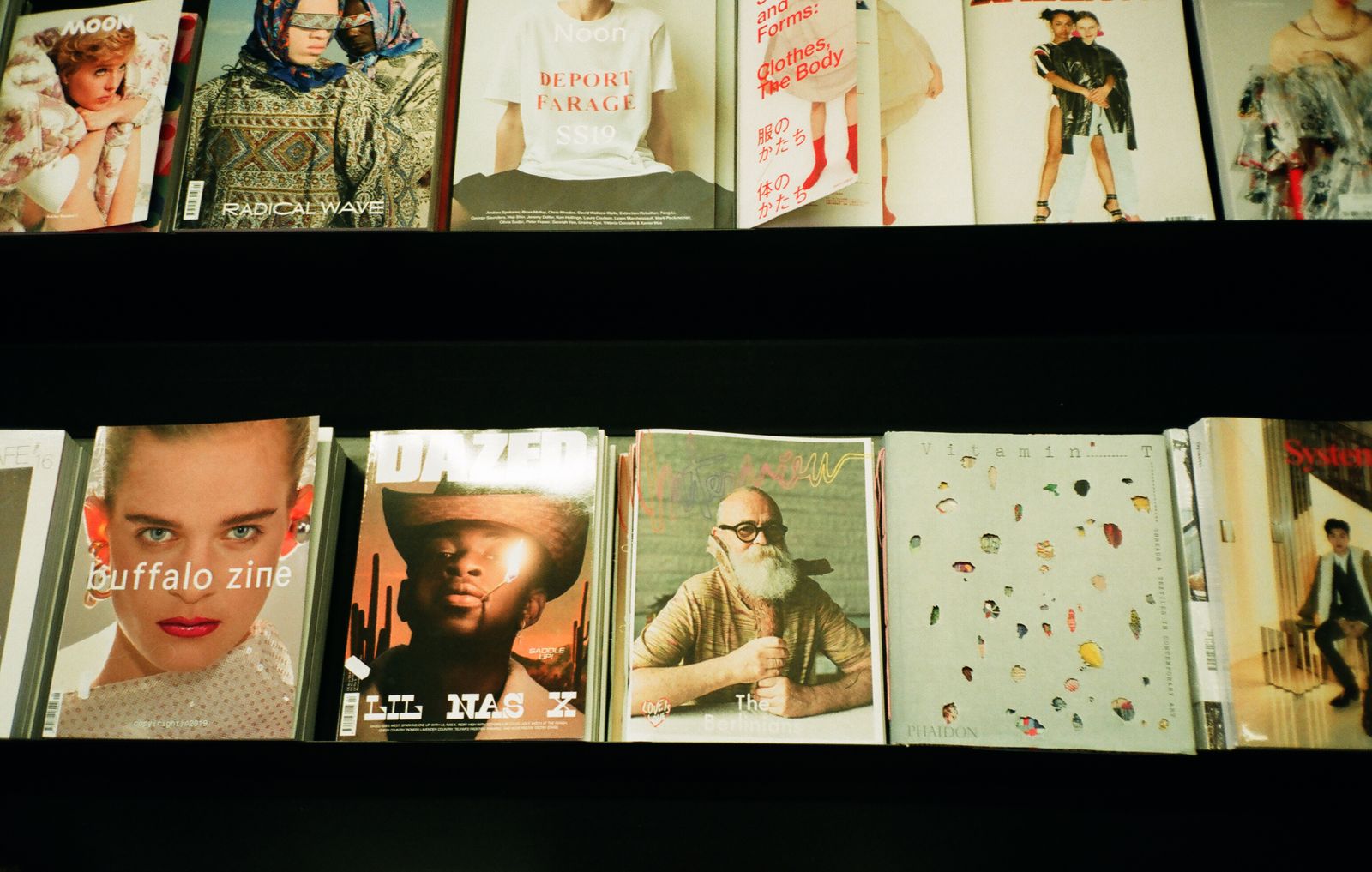 Fashion magazines displayed on retail shelf