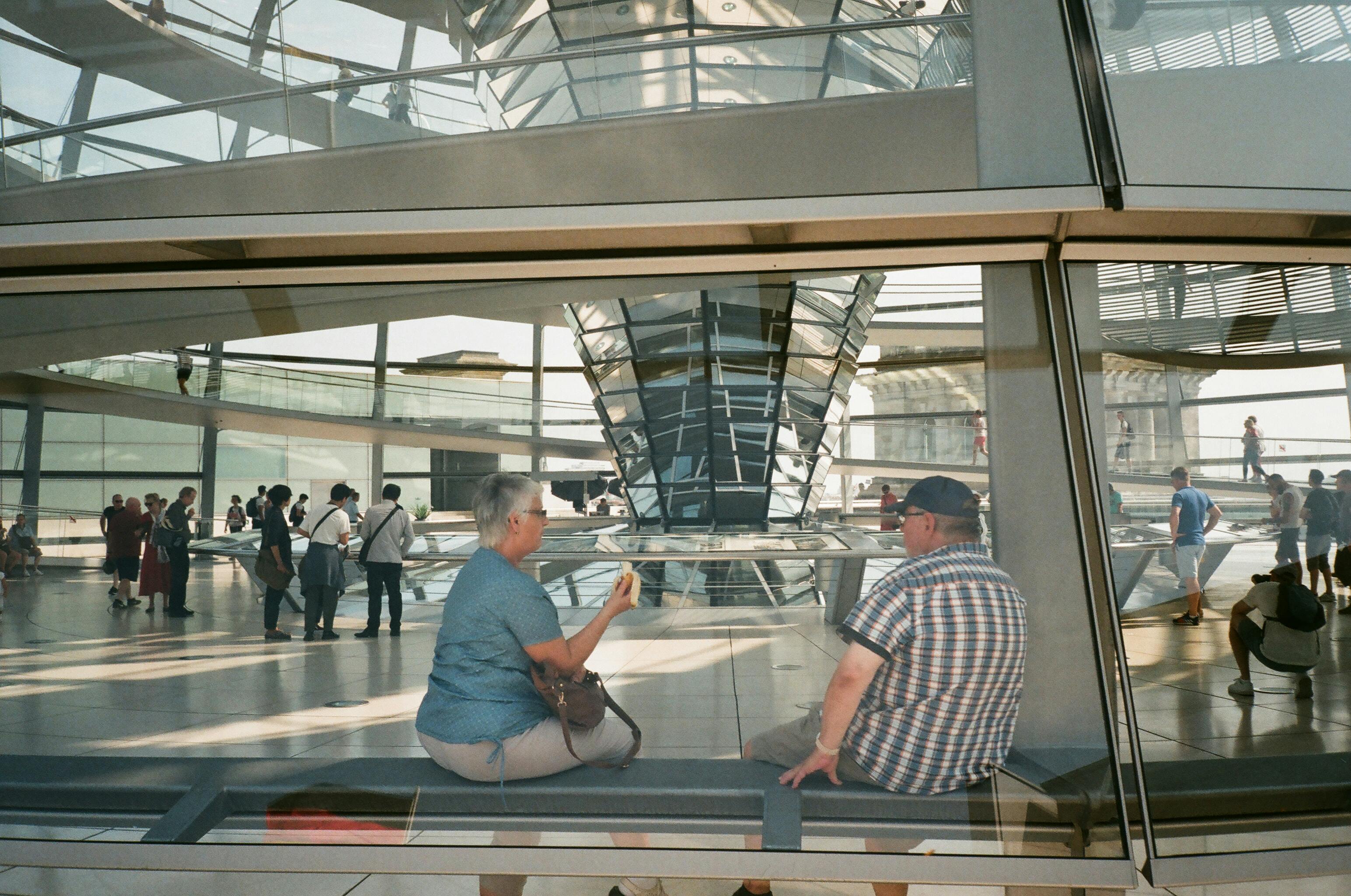 man and woman sitting on waiting area