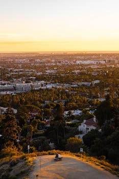 Breathtaking sunset over Los Angeles with sprawling cityscape and lush greenery.