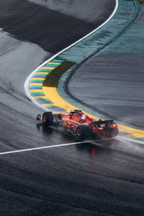 Free Ferrari Formula 1 car navigating a wet curve at Interlagos race track in Brazil. Stock Photo