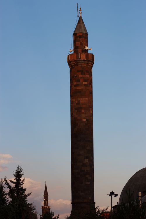 Free A tall brick minaret silhouetted against a clear evening sky. Stock Photo