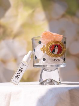 Chic perfume bottle and glass with artistic design, perfect for modern interiors.