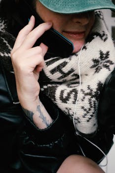 A person in winter clothing talking on the phone, showcasing a cozy lifestyle.