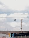 Pair of Shoes Hanging on Electric Wire