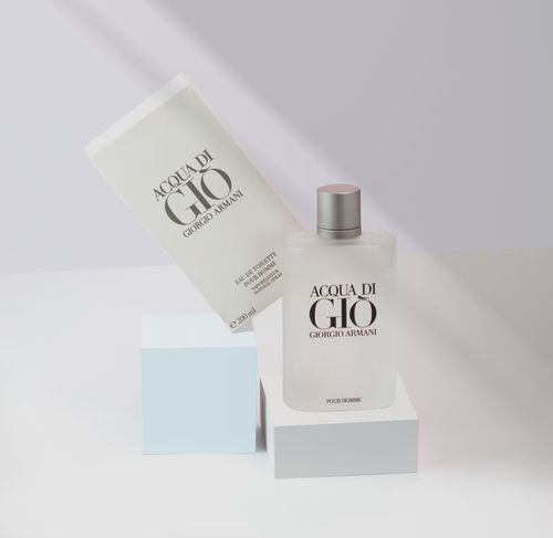 Free Stylish presentation of Acqua di Gio perfume by Giorgio Armani in a minimalist setting. Stock Photo