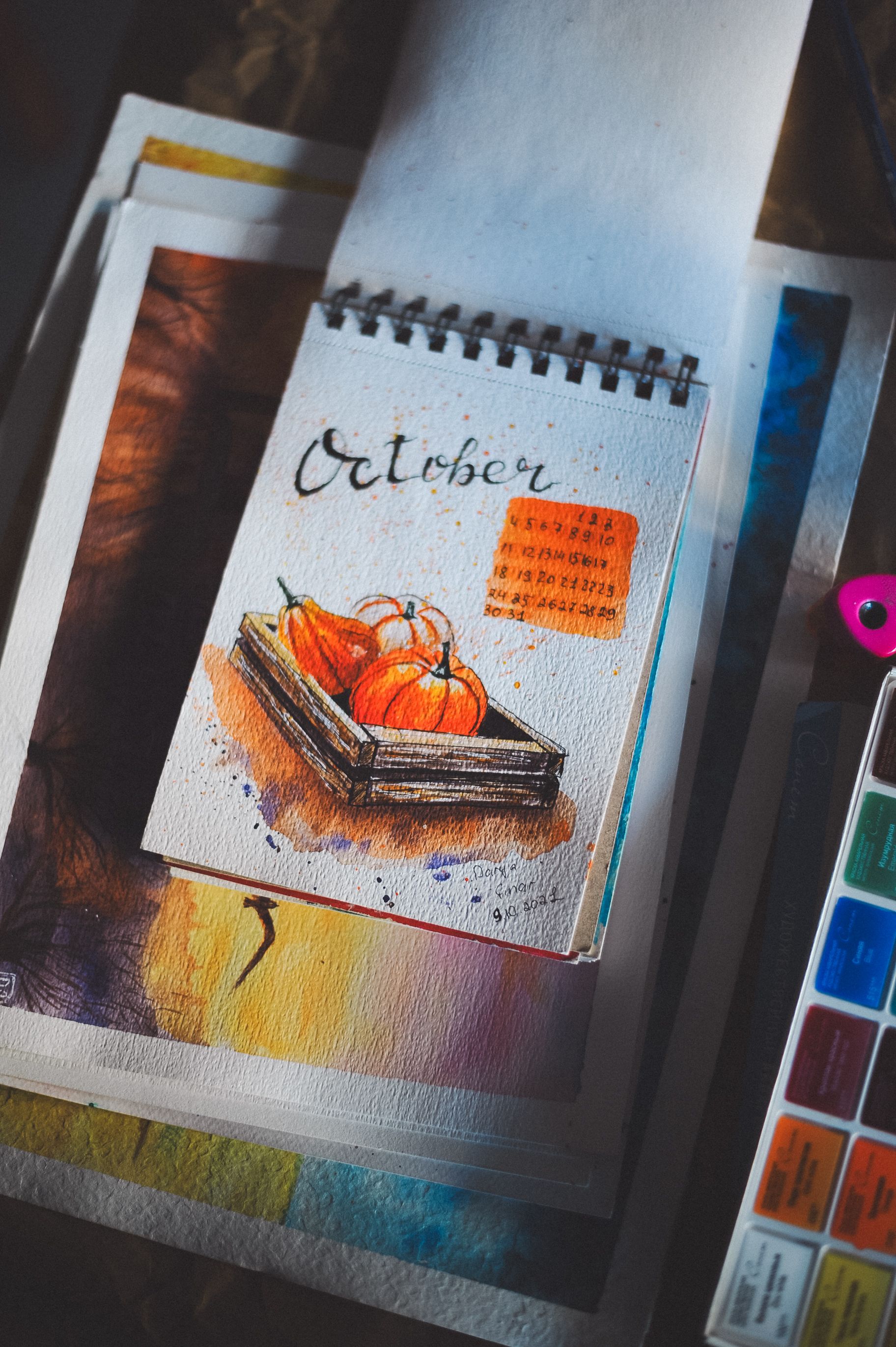 Creative watercolor painting of pumpkins labeled as October, ideal for autumn themes.