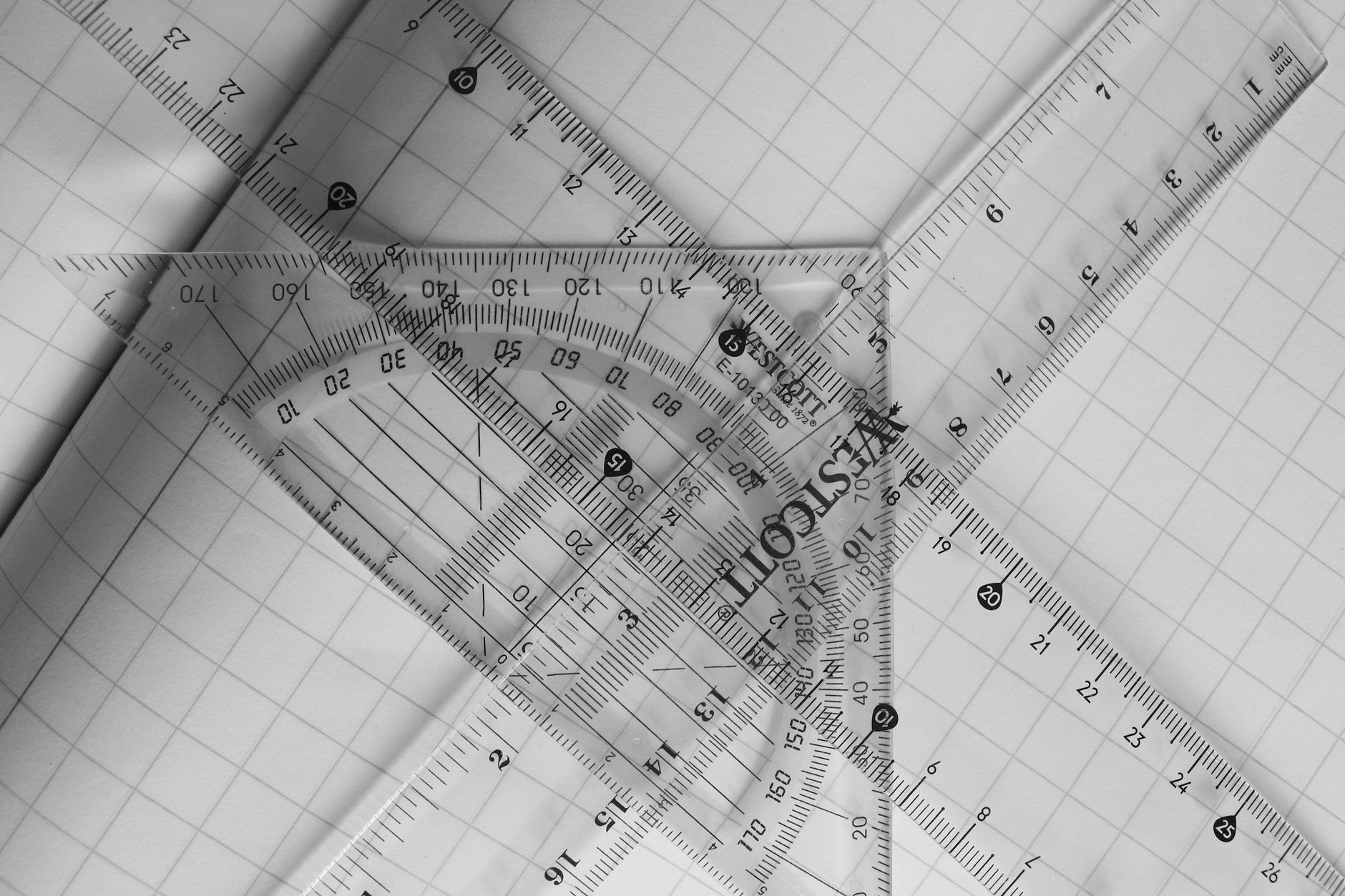 a ruler laid across a blueprint grid measuring out spacing