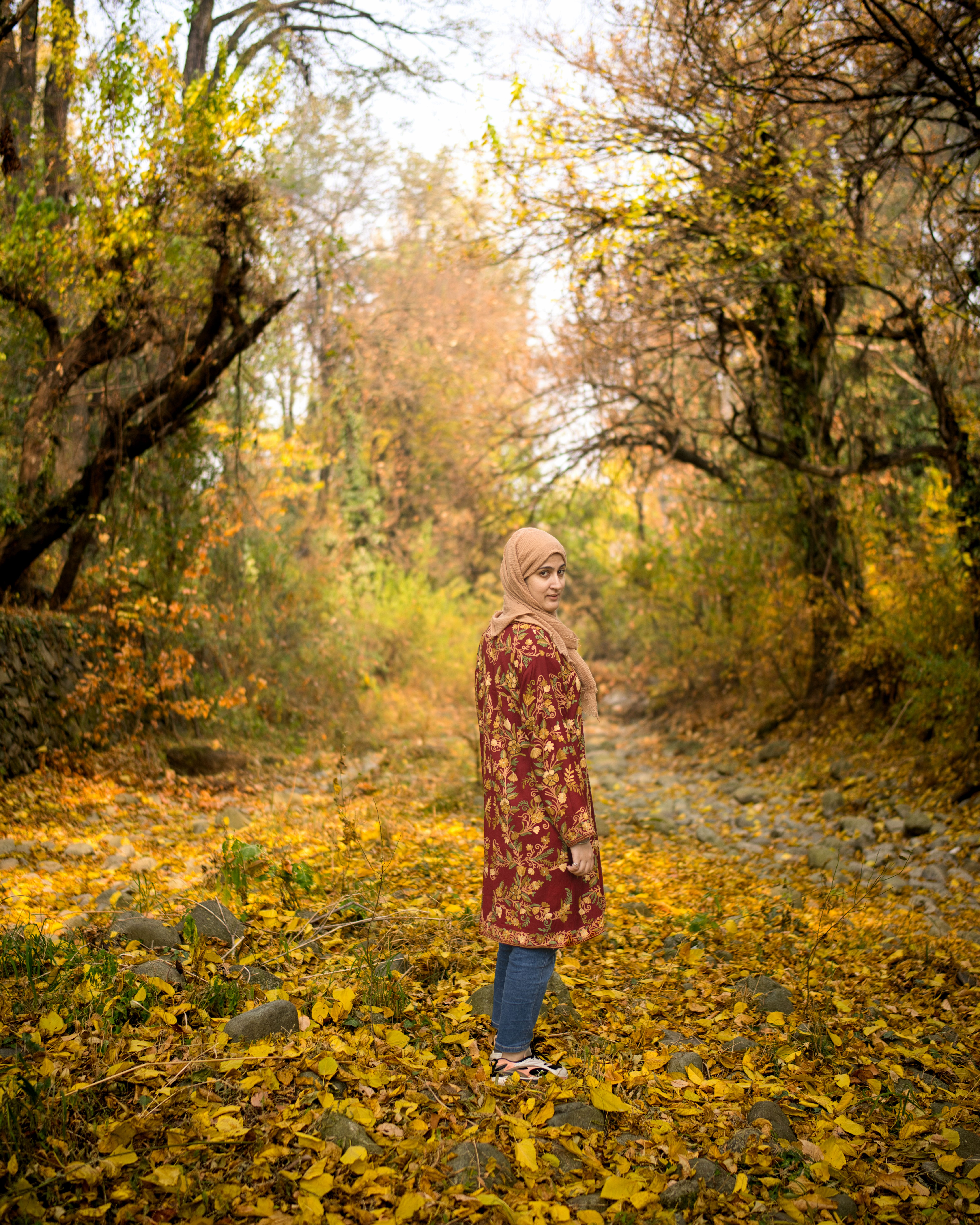 Young woman in colorful autumn forest setting, New Theed.