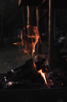 A cozy campfire glowing warmly in a rustic outdoor setting, bringing comfort and light.