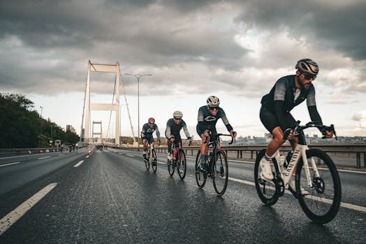 Professional cyclists compete on the Bosphorus Bridge in Istanbul, showcasing endurance and speed.