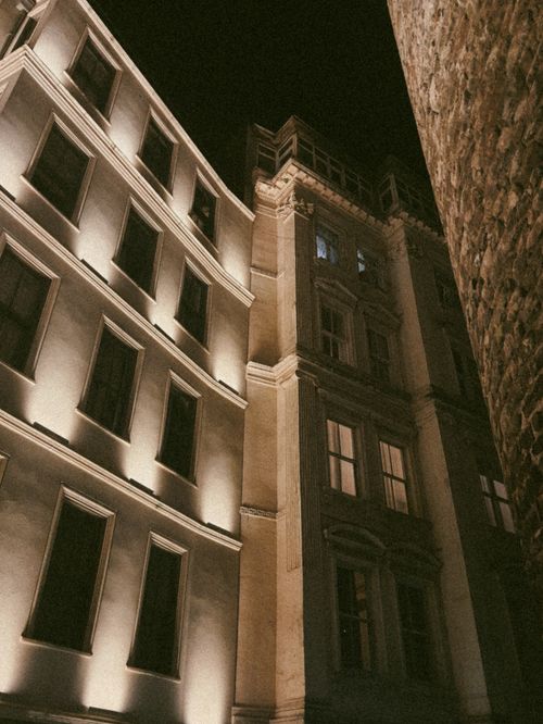 Free A beautifully lit historical building in Istanbul captured at night, showcasing architectural elegance and urban charm. Stock Photo