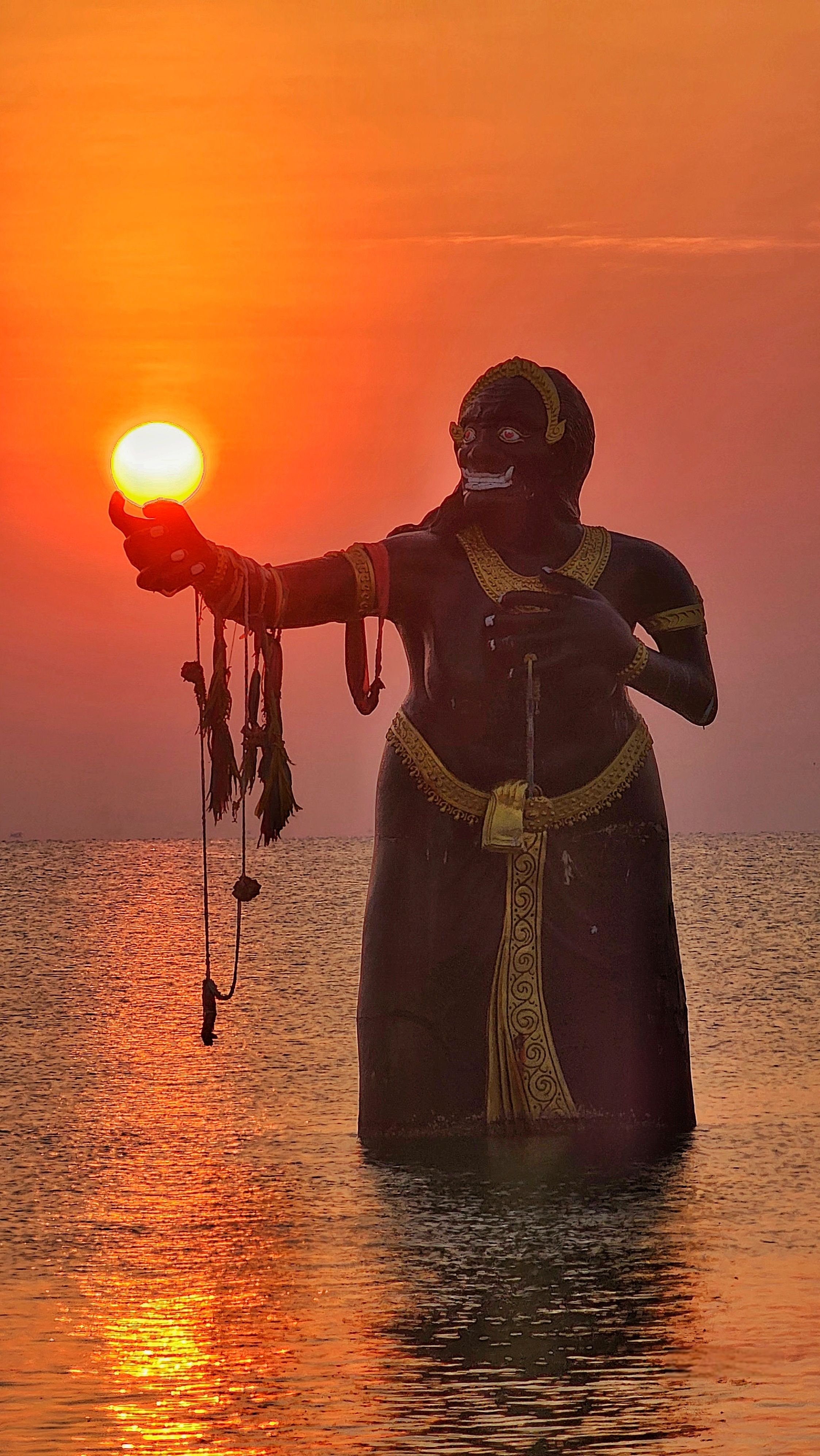 Majestic Statue at Sunset in Serene Waters