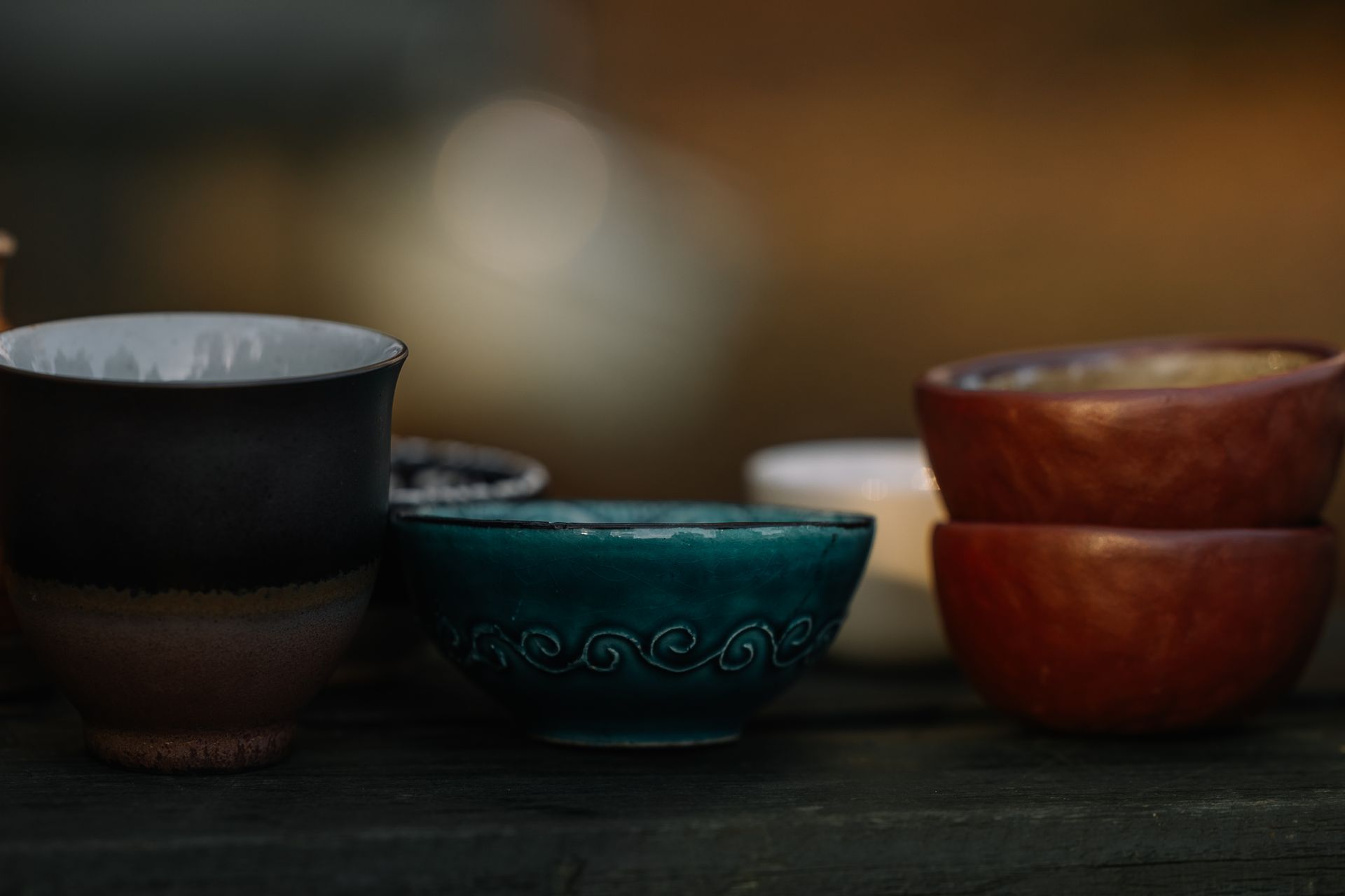 A collection of handcrafted ceramic bowls displaying various textures and colors.