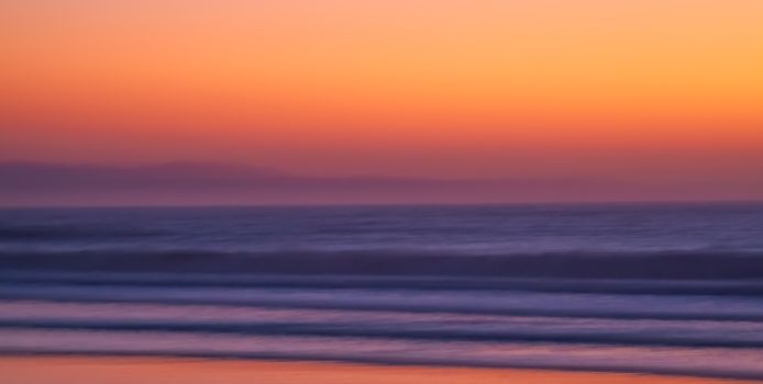 Captivating sunset over the ocean with vivid orange hues in South Africa.
