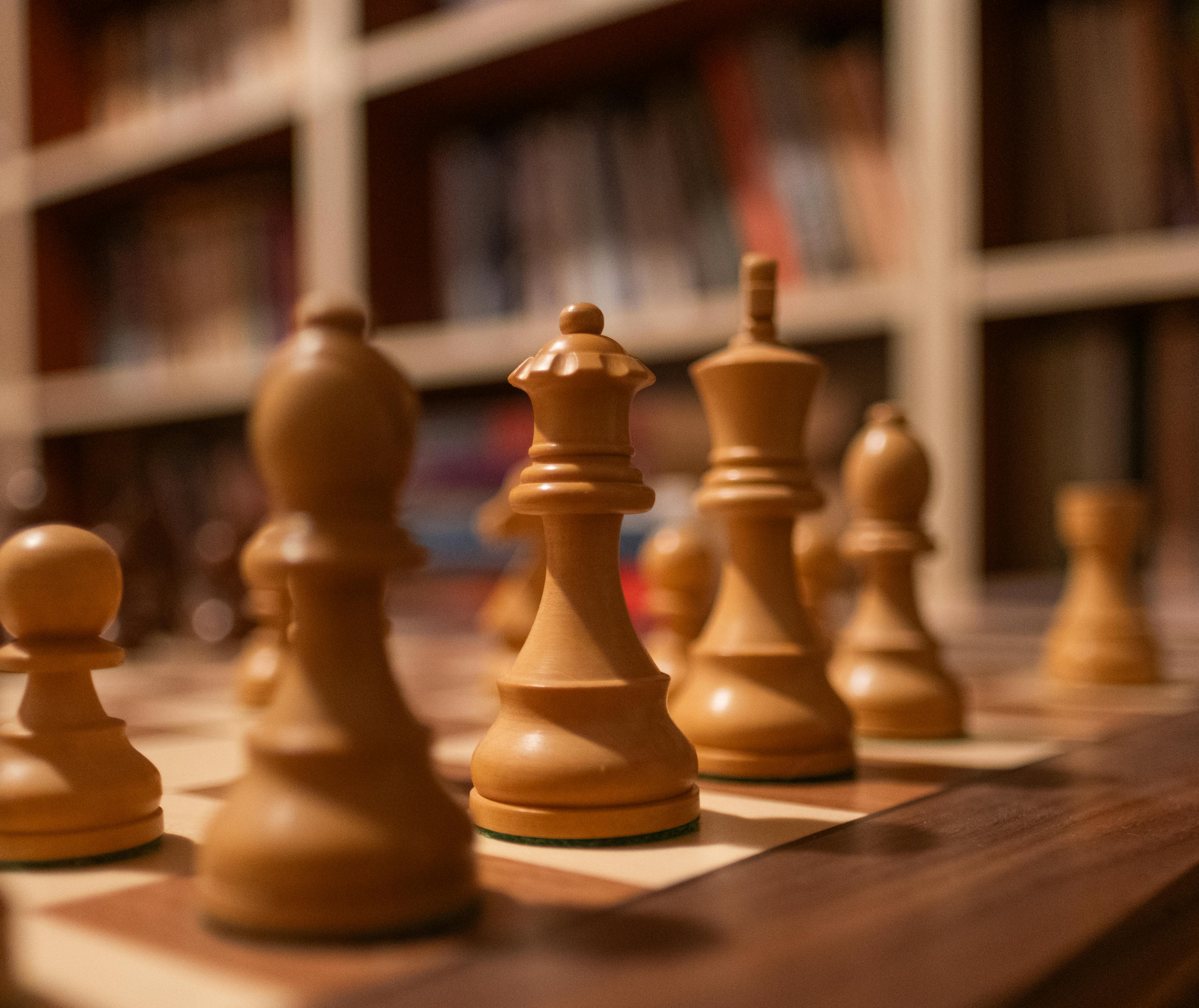 Detailed photo of chess pieces on a wooden board, perfect for strategy themes.