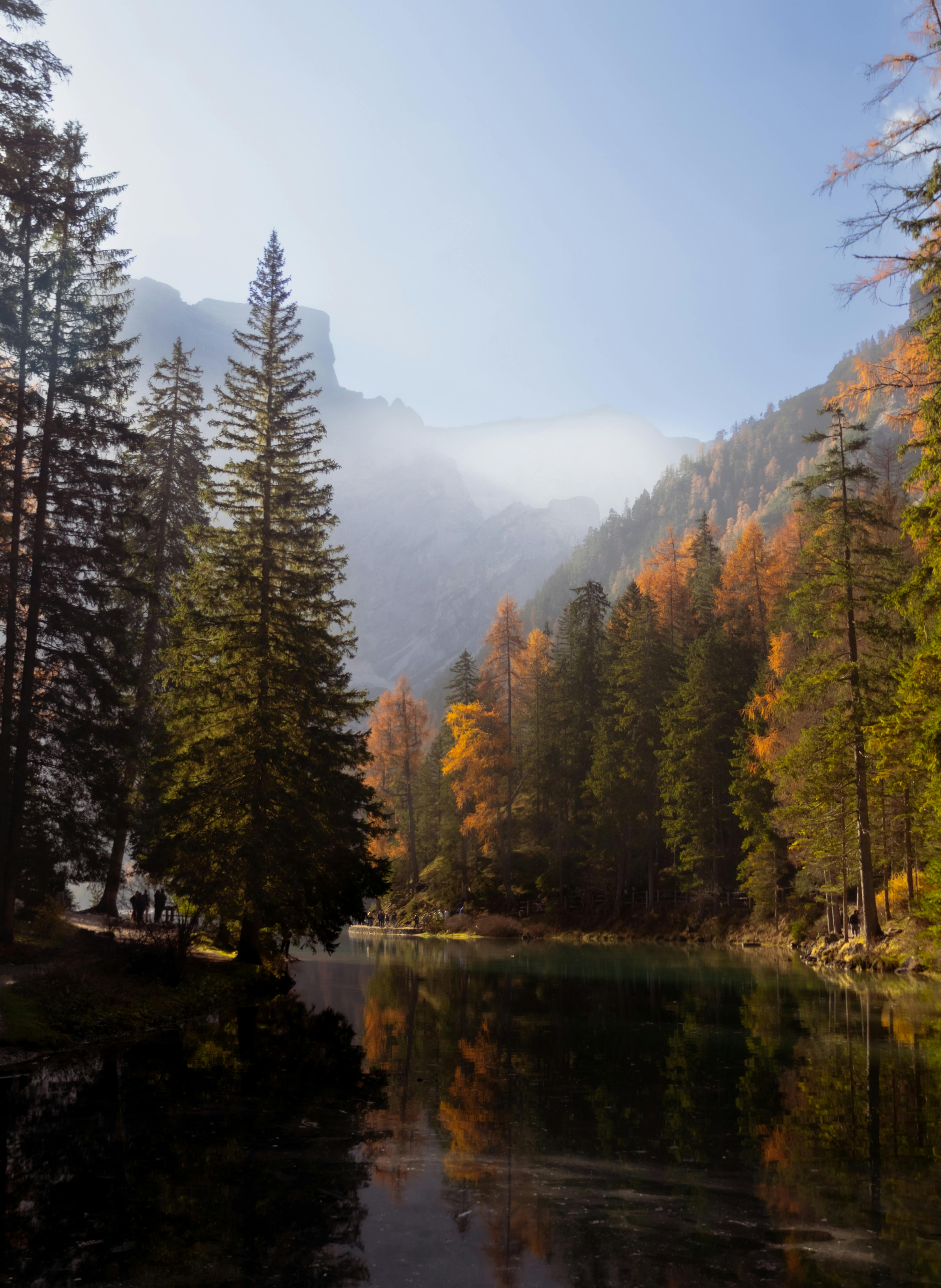 Peaceful autumn morning view of Lago di Braies surrounded by Dolomites.