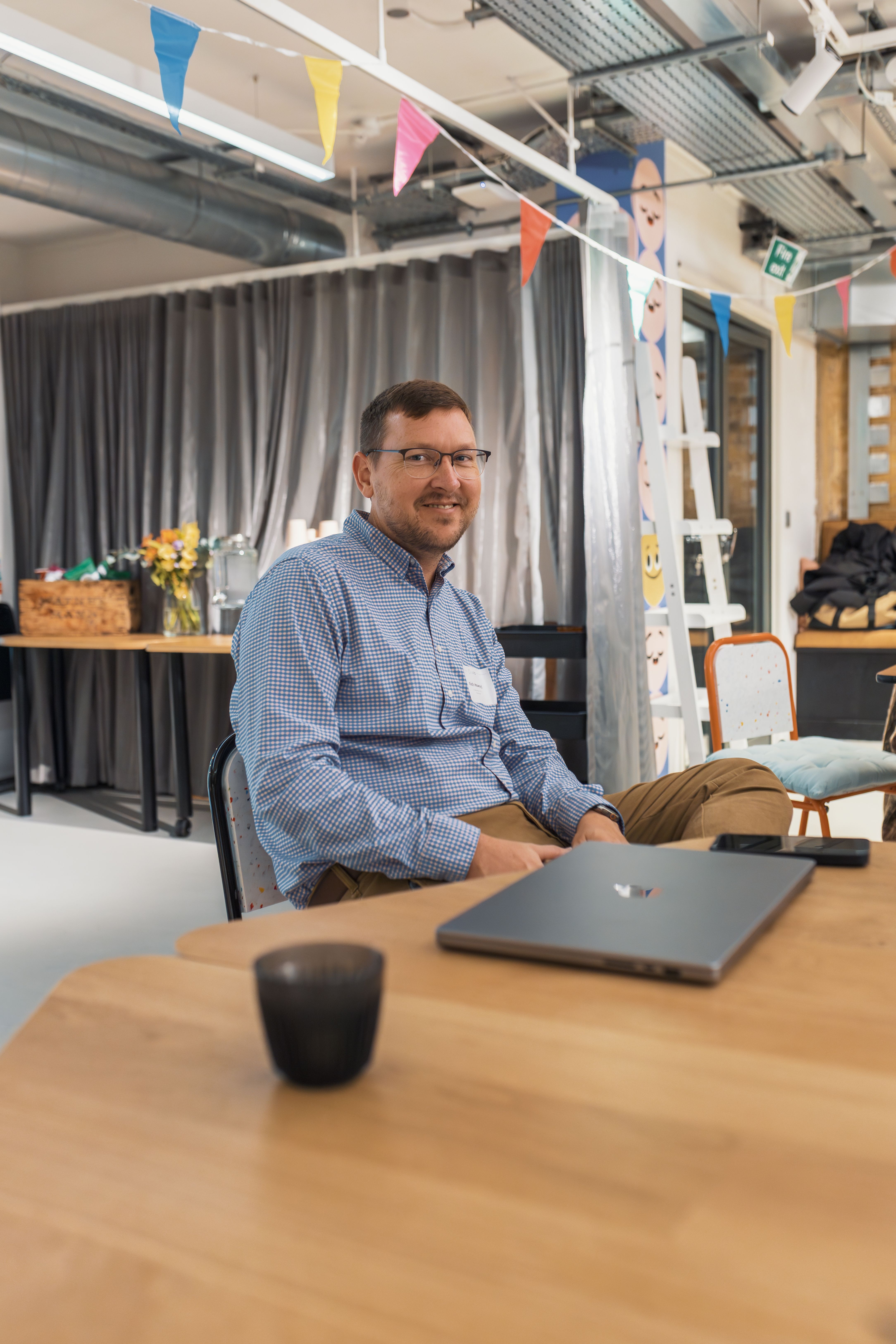 Man sitting at a desk, relaxed atmosphere in a modern office with decor.
