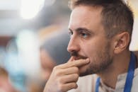 Thoughtful Man in Cafe Setting