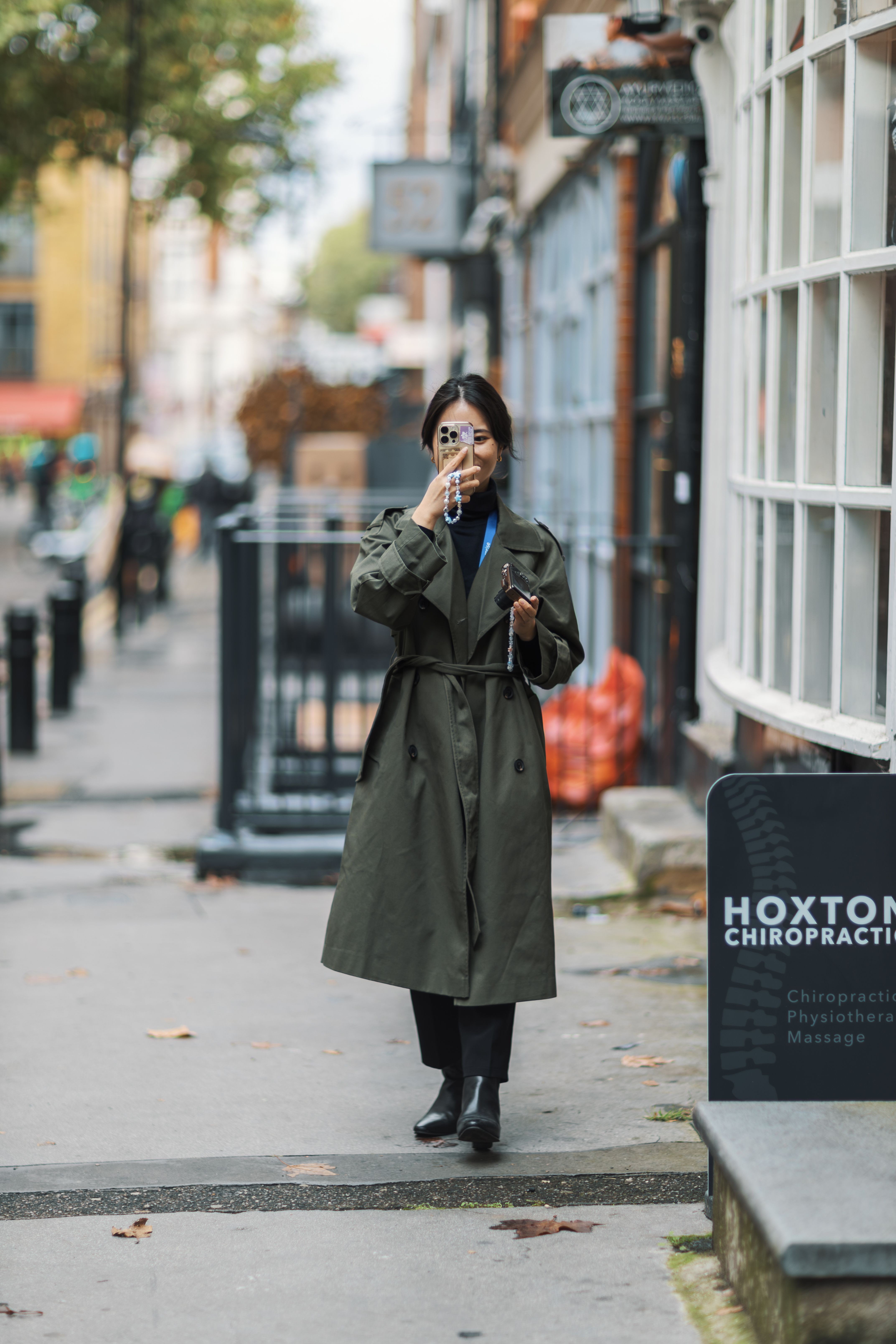 Woman in Trench Coat Walking in Urban Street · Free Stock Photo