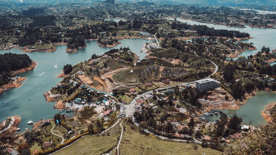 Amazing Guatapé Piedra del Peñol with Helicopter Flight and Boat Trip Review 2026 - A stunning aerial view of the lush countryside in Colombia featuring winding lakes and scattered homes.