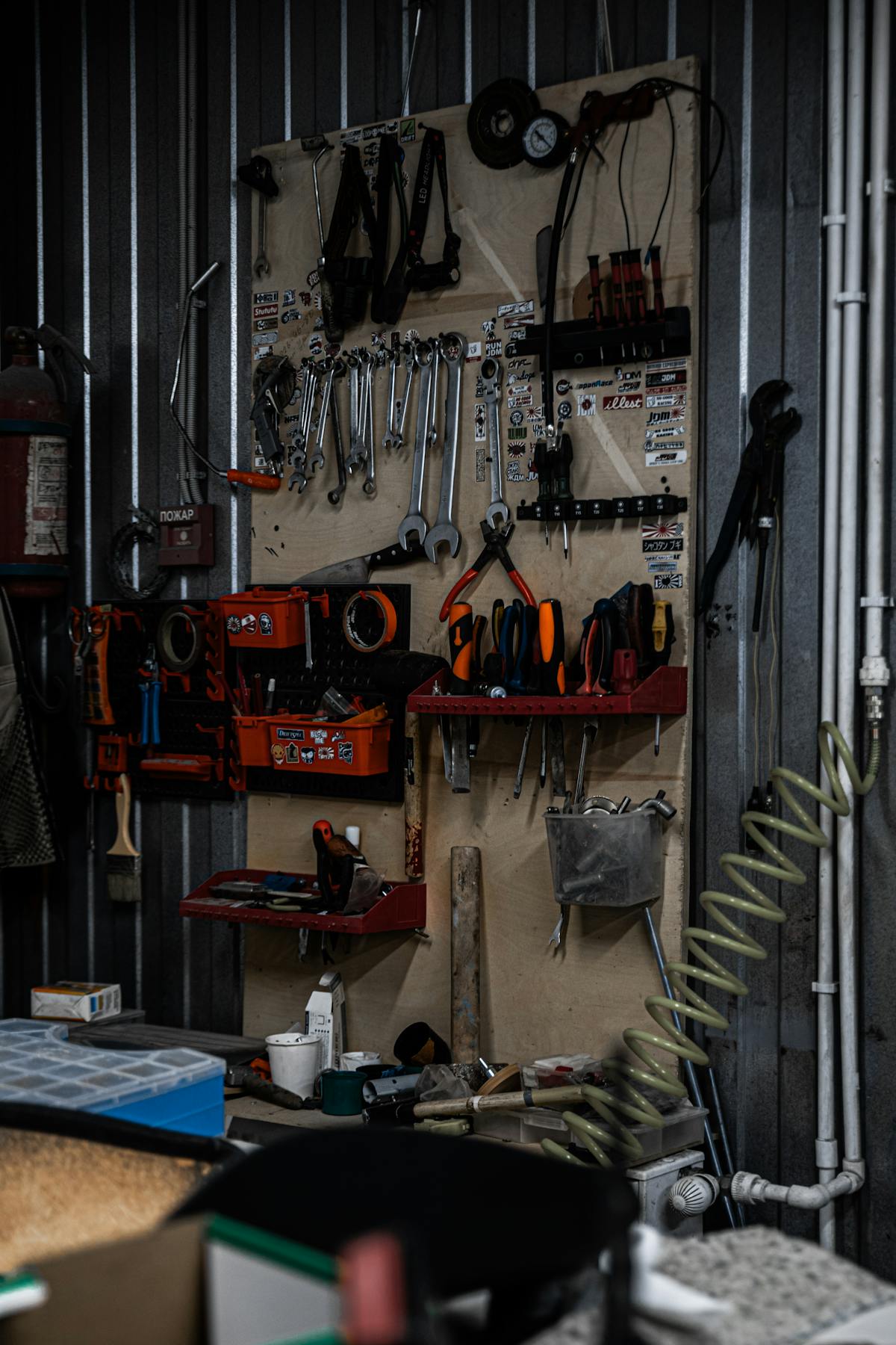 Well-organized garage workshop with tools hanging neatly on walls and workbench ready for projects