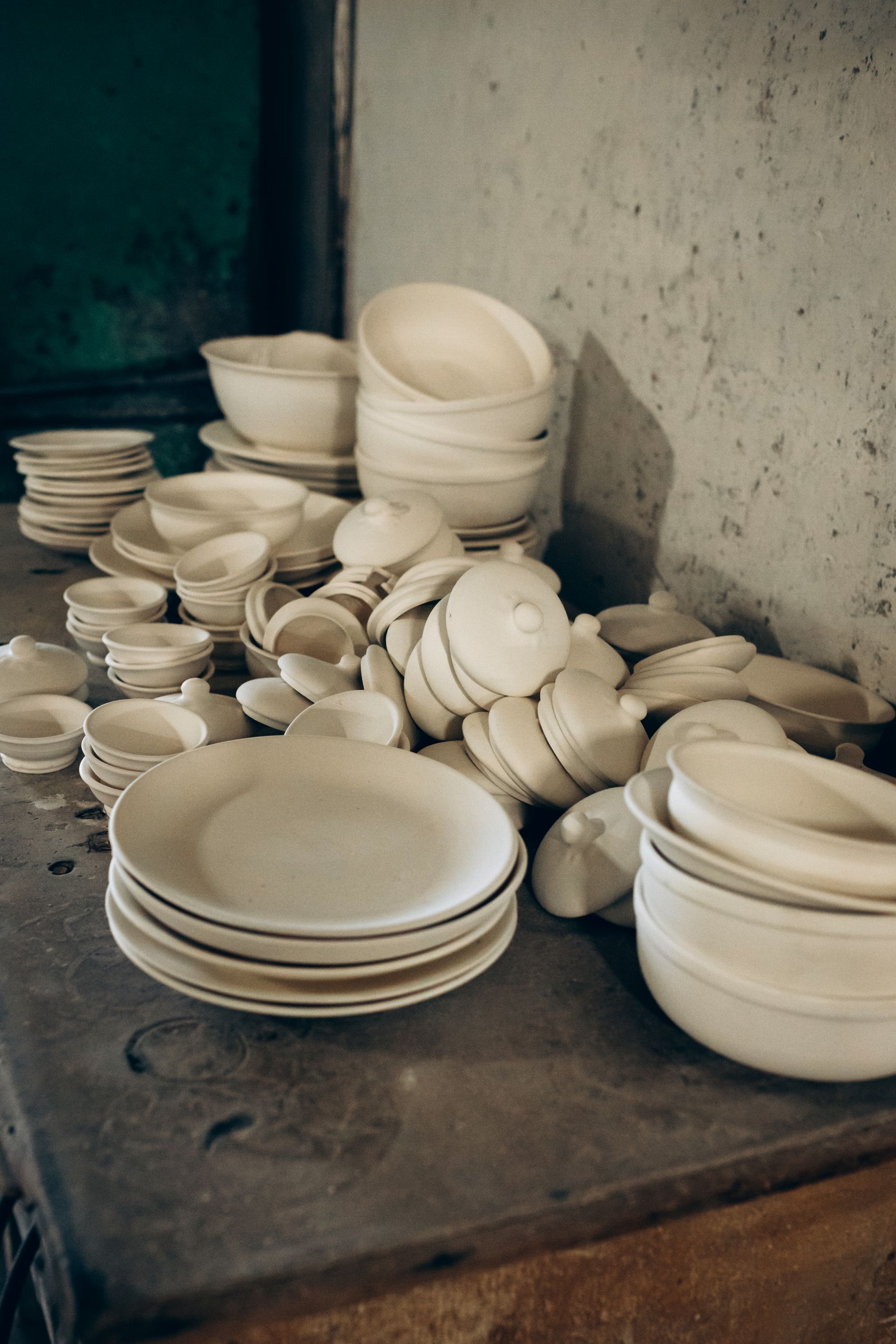 Handmade ceramic tableware in an artisan workshop.