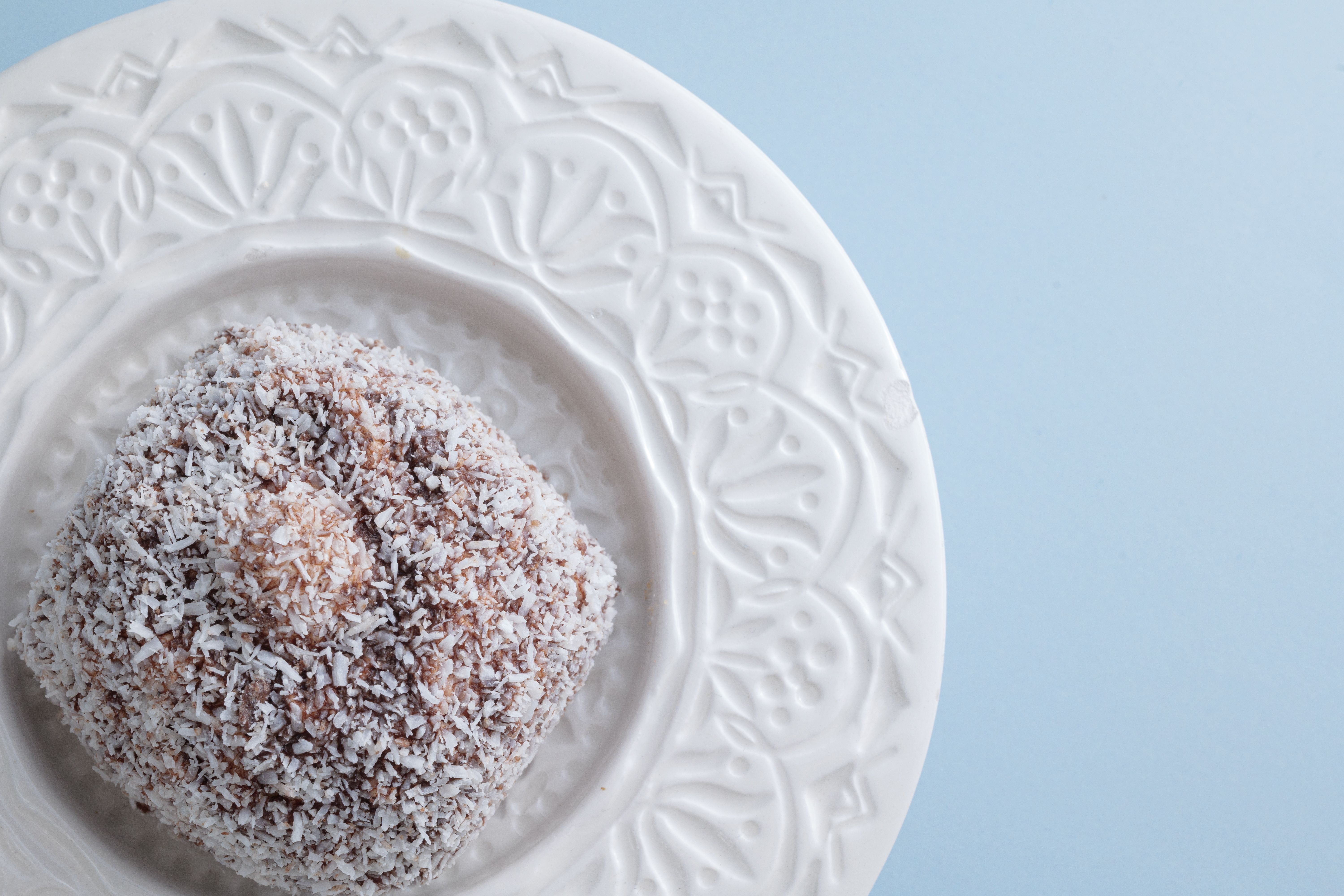 Slice of Gingersnap Coconut Icebox Cake garnished with toasted coconut