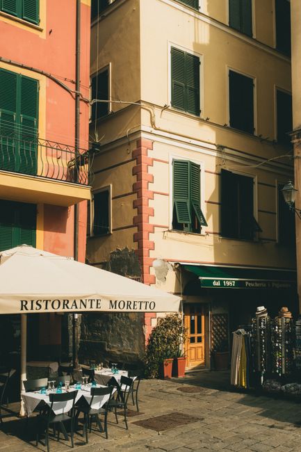 A picturesque outdoor scene of a restaurant in Monterosso al Mare, Italy.