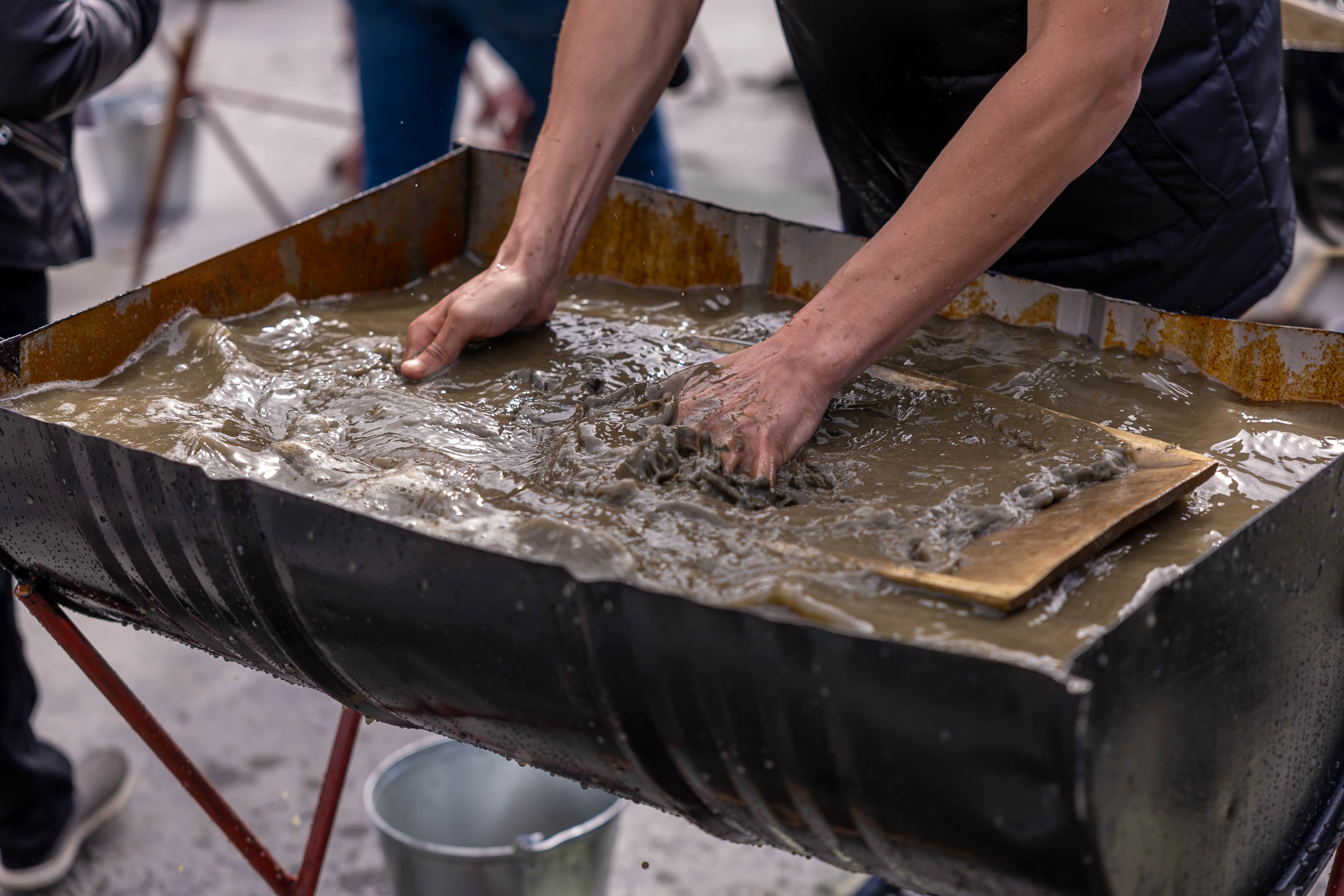 person mixing the hydroseed slurry in a tank - do it yourself hydromulch
