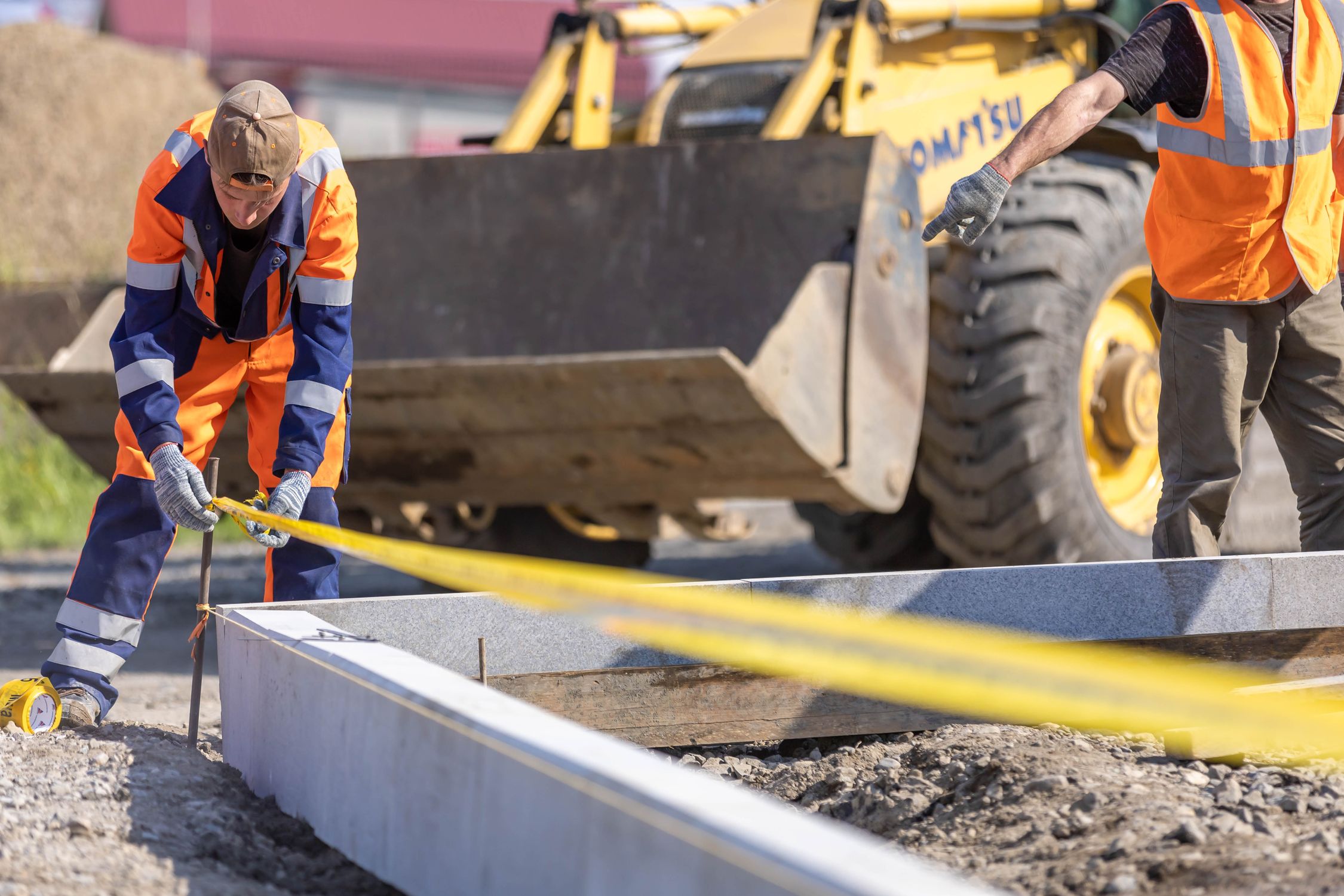 Construction workers measuring at job site outdoors · Free Stock Photo