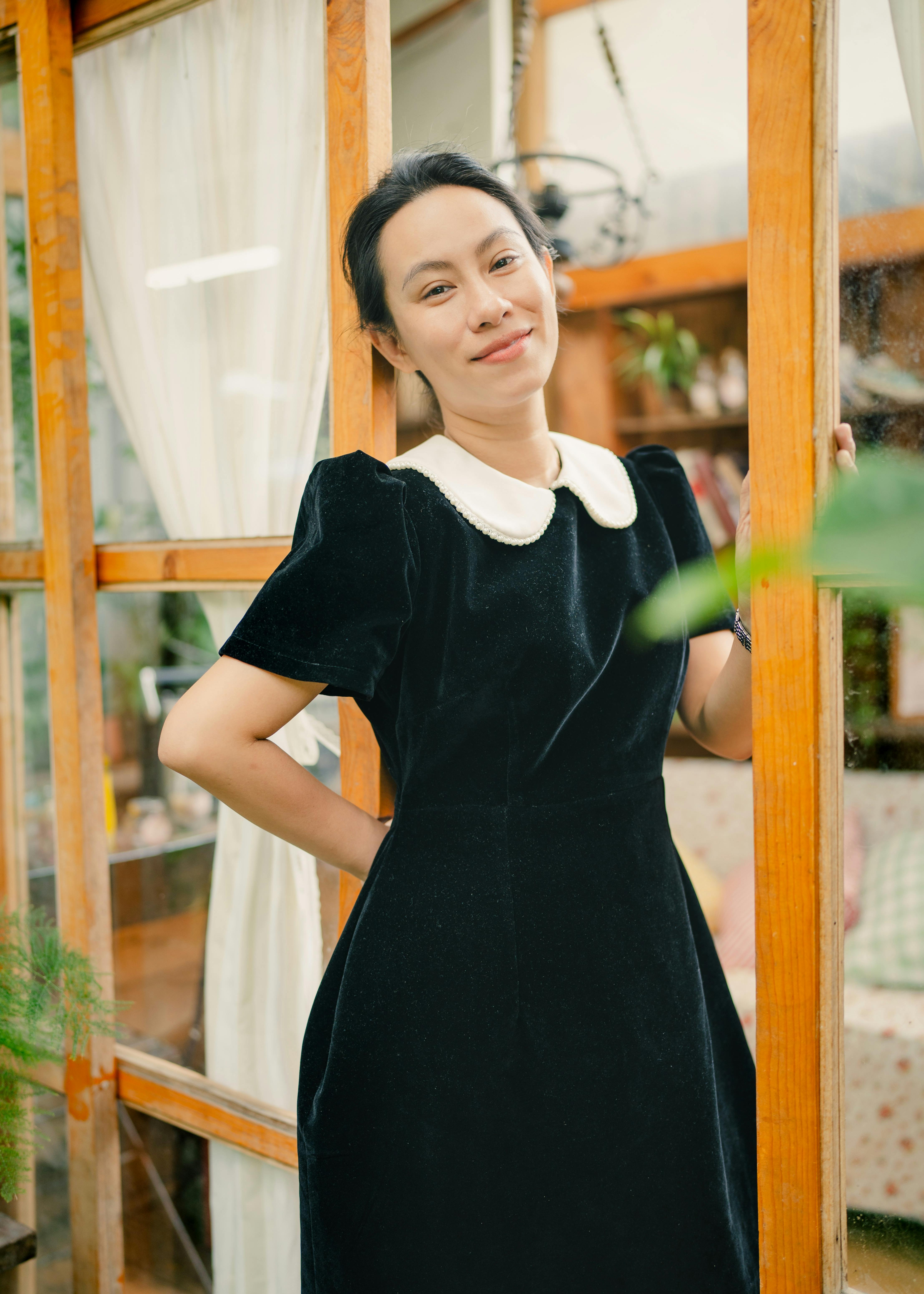 elegant woman in vintage dress by wooden door