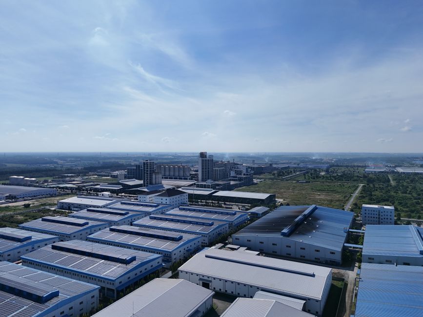 Aerial shot of industrial warehouses under blue sky in Bình Dương, Vietnam.