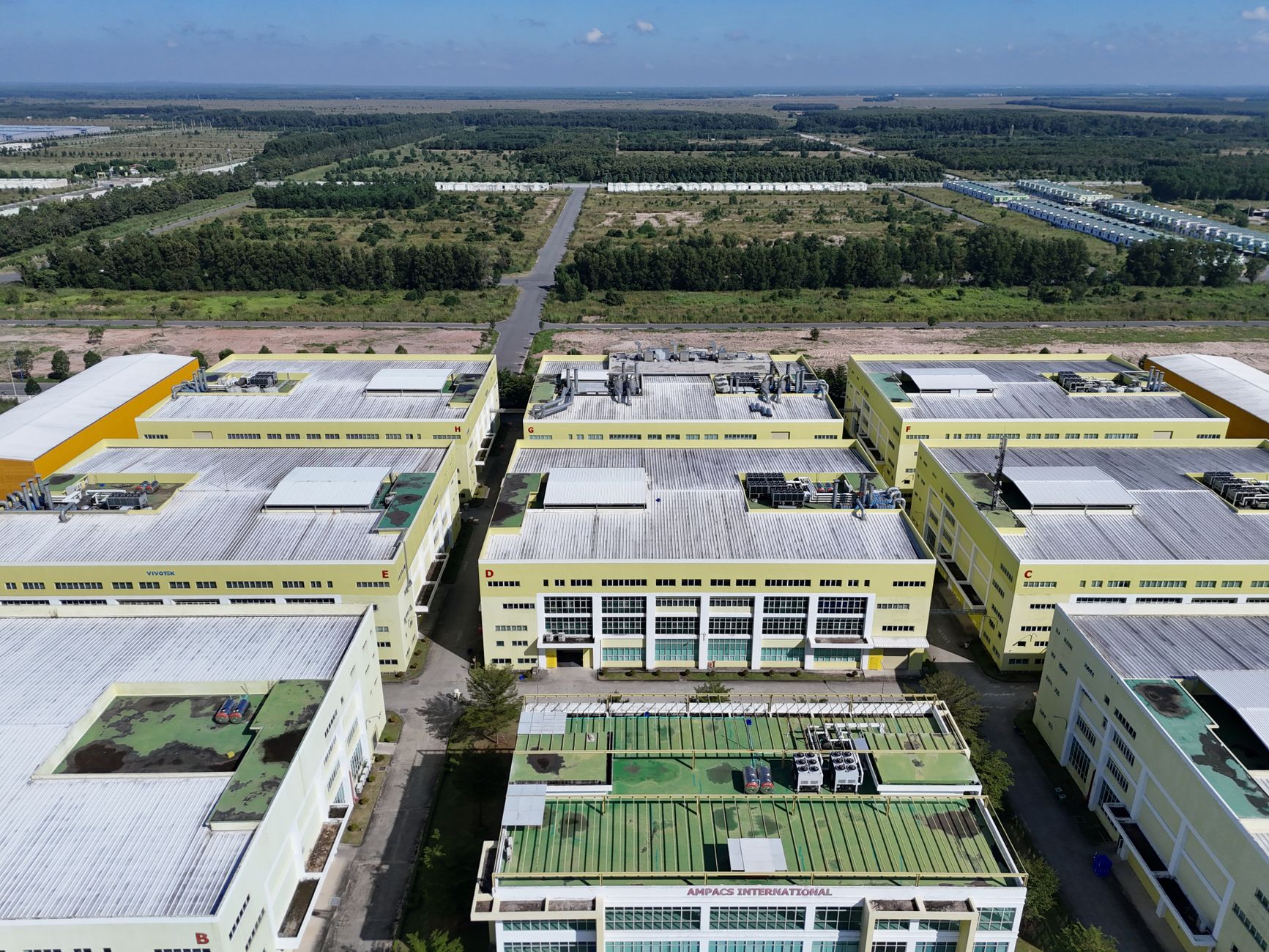 Aerial shot of a modern industrial complex surrounded by greenery in Bình Dương, Vietnam.